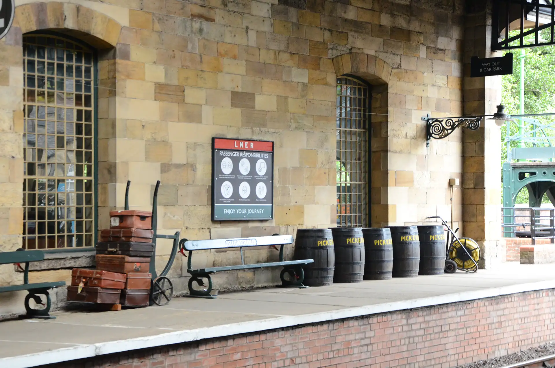 Pickering Train Station platform with vintage luggage and barrels.