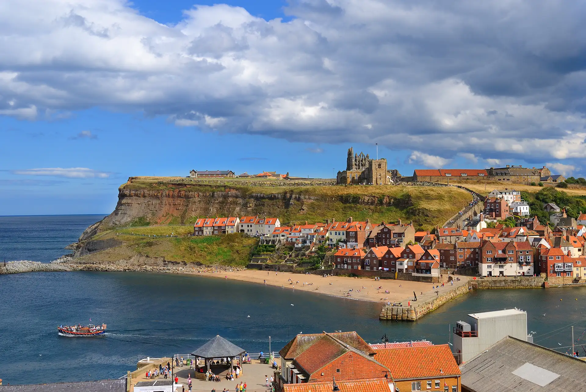 Whitby Abbey and coastal cliffs overlooking the town and sea.