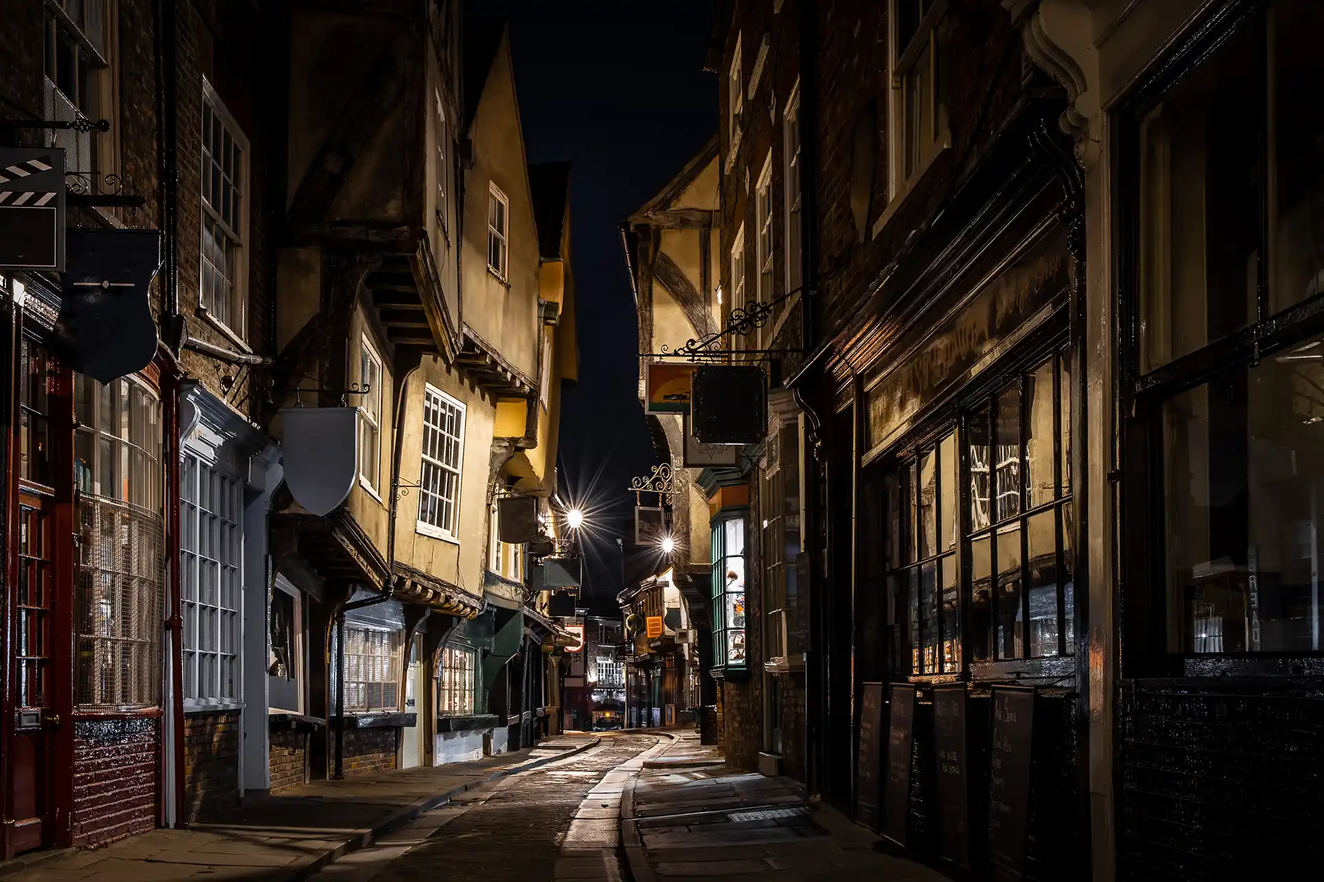 Night view of The Shambles, York’s famous medieval street, illuminated with shop lights, near Paradise Lakeside Lodges.